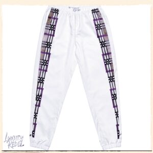 White joggers with a plaid and checkerboard pattern running down the sides, part of the Luxury Rebel collection