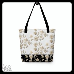 A tote bag featuring an elegant floral pattern in beige and cream tones, with a black base, named the Elegance in Bloom Tote, part of the Luxury Rebel collection.