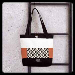 Tote bag featuring a sophisticated design with geometric patterns in black, white, and terracotta color blocks. Named Eternal Elegance Tote, part of the Luxury Rebel collection.