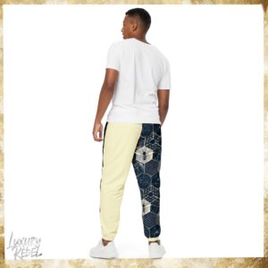 Joggers featuring a unique design with geometric patterns and bee motifs in black, white, and cream color blocks. Named Imperial Joggers, part of the Luxury Rebel collection.