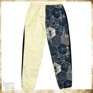 Joggers featuring a unique design with geometric patterns and bee motifs in black, white, and cream color blocks. Named Imperial Joggers, part of the Luxury Rebel collection.