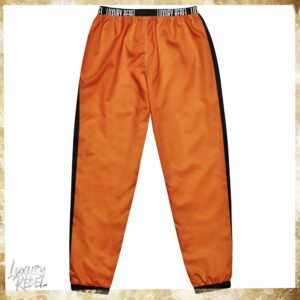  Joggers featuring a bold design with vibrant autumn orange and black color blocks, named Luxury Rebel Autumn Orange & Black Joggers, part of the Luxury Rebel collection.