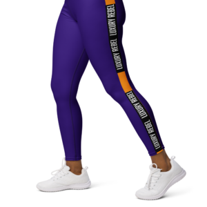 Luxury Rebel Fab High-Waisted Leggings, featuring a deep purple design with orange accents and "Luxury Rebel" text running along the sides. The leggings have a high waistband with the "Luxury Rebel" logo, offering a stylish and supportive fit perfect for workouts or casual wear.