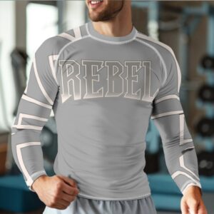 A long-sleeve compression shirt featuring a grey base with bold 'Rebel' typography and white geometric accents. The shirt is made with moisture-wicking fabric and a snug fit, designed for athletic performance and modern style.