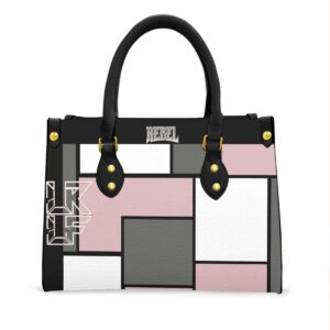 A stylish tote bag featuring a geometric block design in pink, white, black, and gray. The bag has sturdy black handles, gold-tone accents, and a spacious interior, making it perfect for daily use while adding a chic and modern flair.