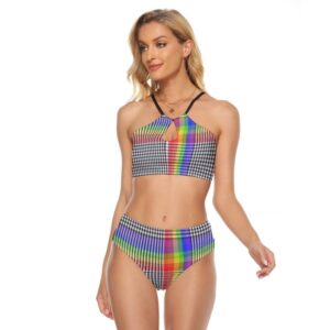 A woman in a high-waisted two-piece swimsuit with a bold, abstract red, orange, and black geometric print on white fabric. The top features a cami style with a front keyhole and thin black crisscross straps.